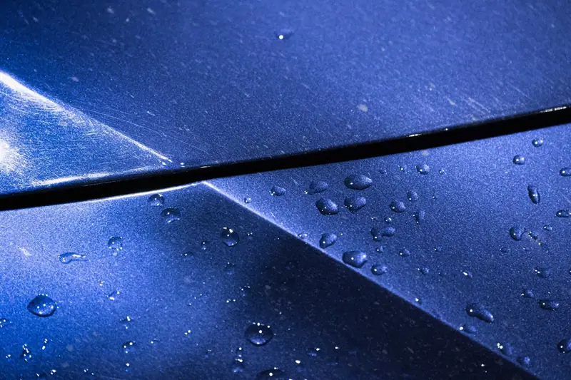 Water beads on deep blue metallic paint