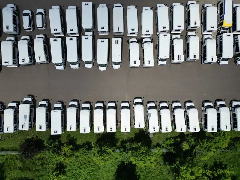 Aerial view of white work vans in a lot
