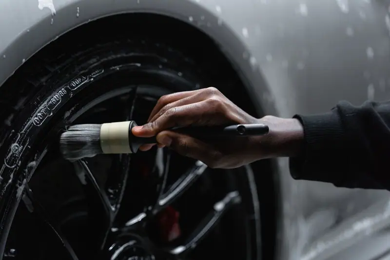 Detail brush cleaning a tire and wheel