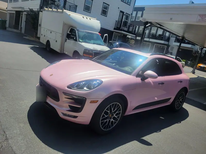 The same Porsche Macan after a pink satin vinyl wrap