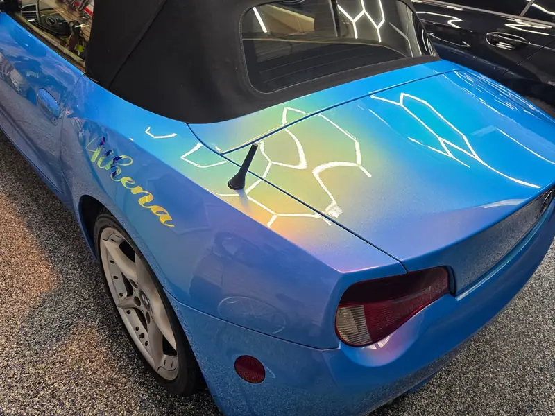 Blue BMW Z4 rear deck reflecting hexagon lights