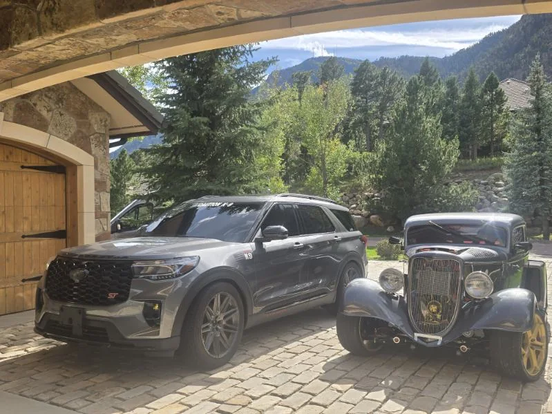 Gray Ford Explorer ST beside the gray 1930s Ford coupe hot rod at the same home
