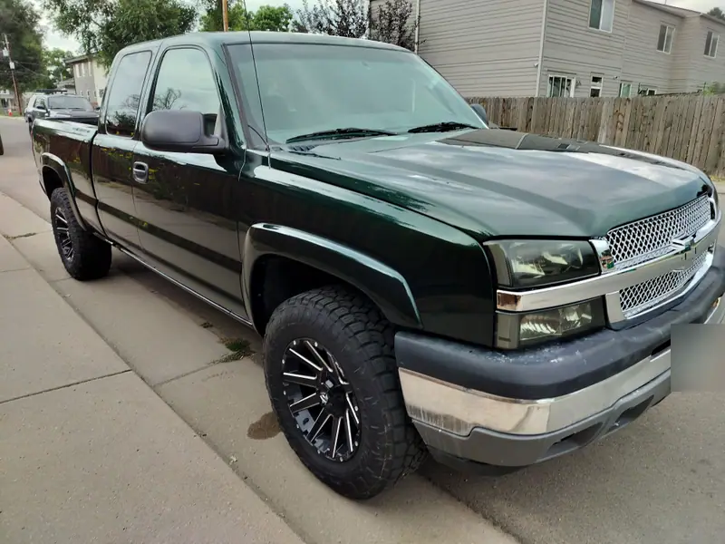Dark green Chevy Silverado pickup with polished, coated paint