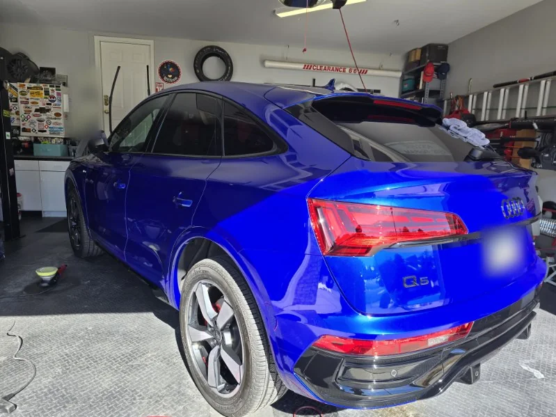 Blue Audi Q5 Sportback rear three quarter view with glossy paint