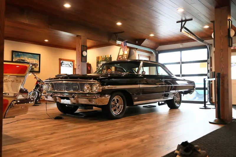 Classic American car with deep black paint in a garage