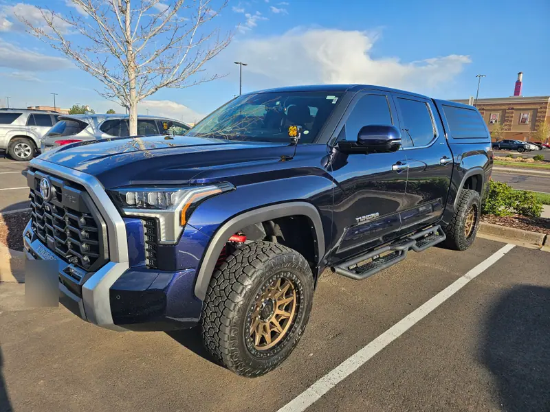 Navy Toyota Tundra with bronze wheels after detailing, from a customer photo on the Patriot Ceramics Google profile